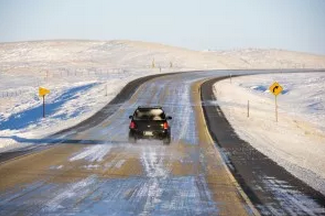 picture of car driving down an icy road