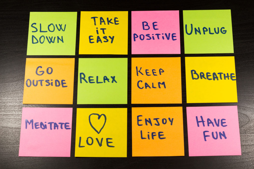 slow down, relax, take it easy, keep calm, love, enjoy life, have fun and other motivational lifestyle reminders on colorful sticky notes