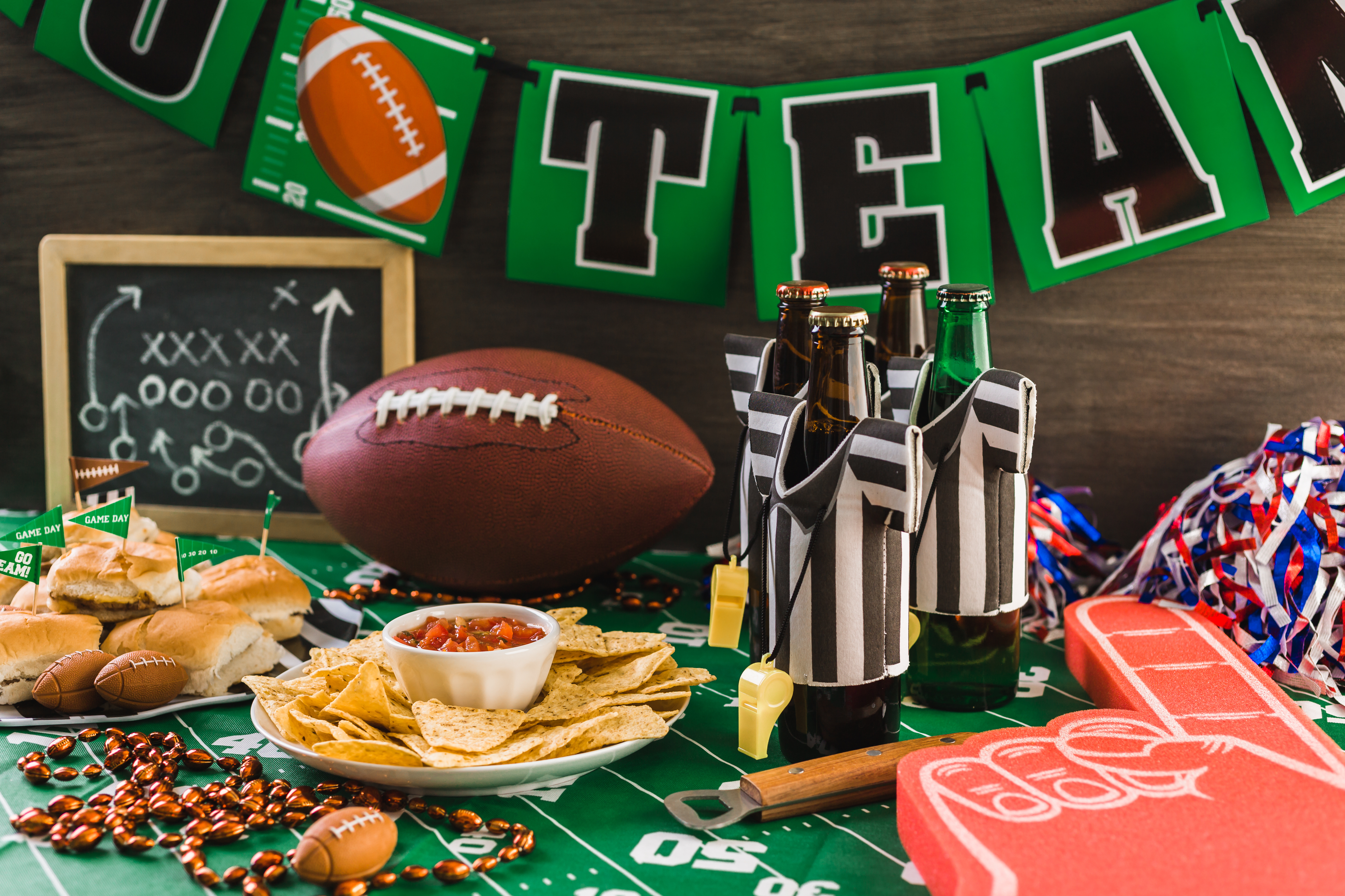 Game day football party table with beer, chips and salsa.