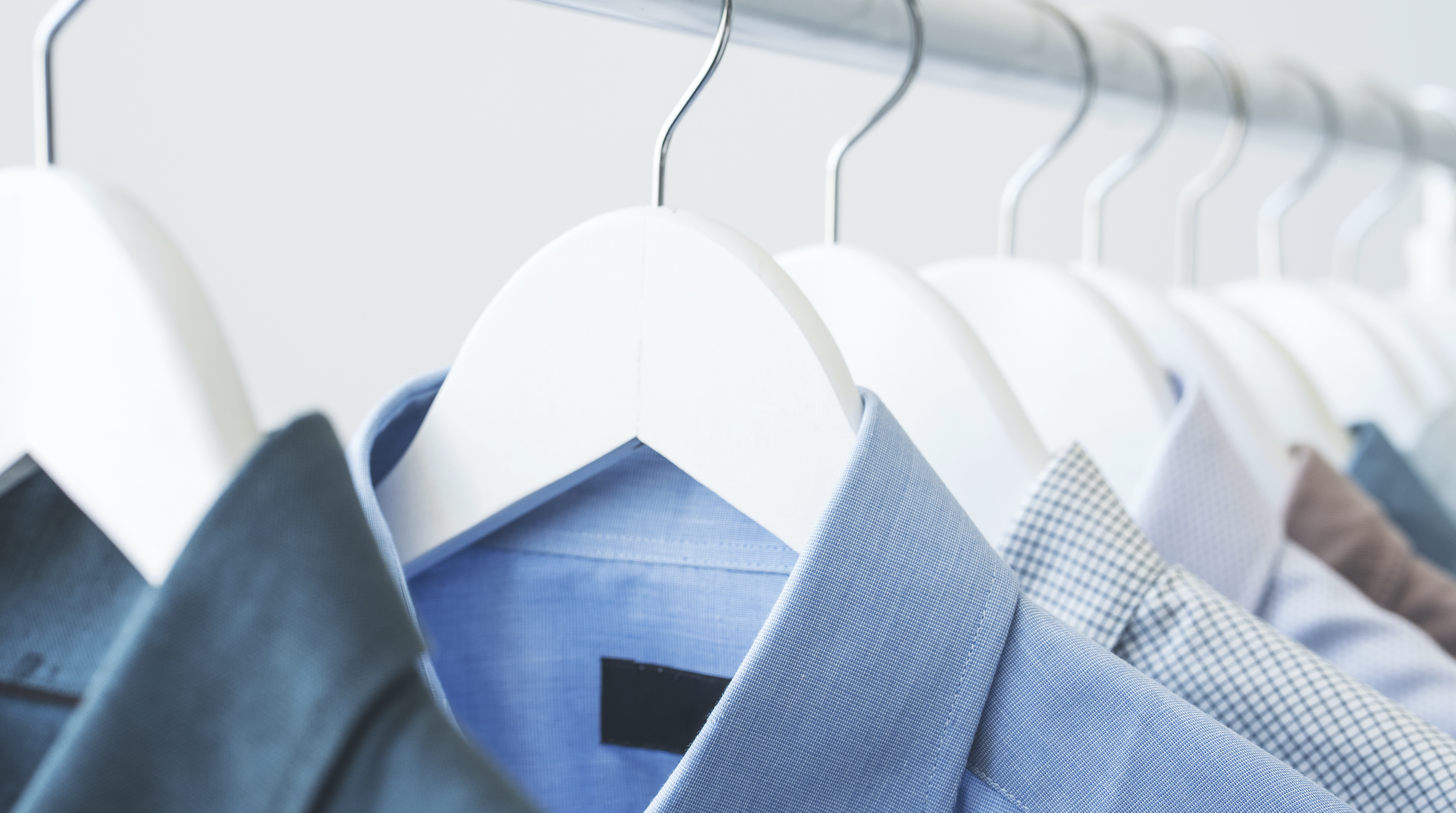 dress shirts hanging in a line