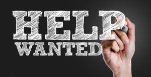 Hand writing the text: Help Wanted